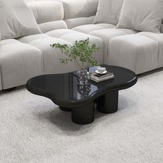 a black coffee table sitting on top of a white carpeted floor next to a couch