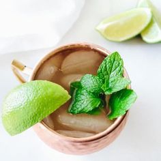 a drink in a copper mug with mint and lime