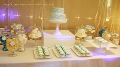 a table topped with lots of cakes and cupcakes