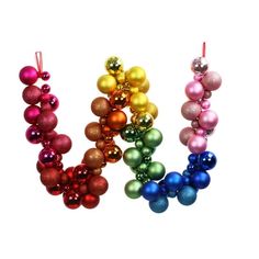 three different colored ornaments hanging from strings