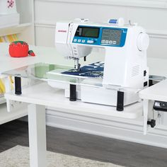 a sewing machine sitting on top of a white table