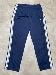 These pants are super hip, and ultra rare. They are old school Nike. They are clean and fresh. There is one spot with some pilling, it's near the waistband on the back, shouldn't be too noticeable. See the last photo. They must be bought to be worn.  Brand: Nike Size: XL Material: Polyester Measurements in inches Waist 36-40 Inseam 34 1/3.8 #33 I do accept returns within 30 days of purchase of all vintage items. The item must be in the same condition in which it shipped and preferably with the t Vintage Nike Pants, Nike Hose, Nike Vintage, Y2k 2000s, Pants Blue, Mens Trousers, Vintage Nike, Nike Pants, Old School