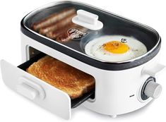 a toaster with an egg in it and two slices of bread on the side