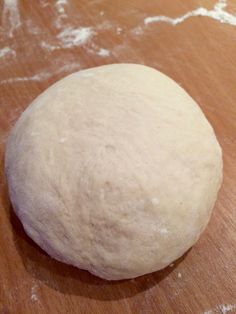 a ball of dough sitting on top of a wooden table