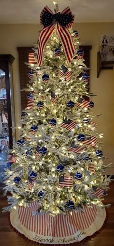 a white christmas tree with red, white and blue decorations