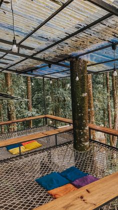 a hammock in the middle of a forest filled with lots of trees and hanging lights