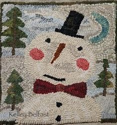 a close up of a rug with a snowman on it's face and trees in the background