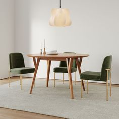 a dining room table with two chairs and a rug on the floor in front of it