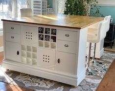 a kitchen island with two stools in front of it