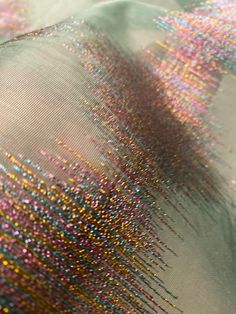 the fabric is covered with colorful sequins