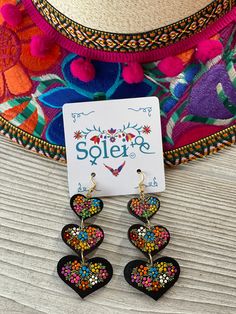 These beautiful earrings are hand painted on wood.  It is the perfect accessory and pop of color for your outfit! Every piece is completely unique because of the detailed process that goes into creating it.  The black lacquer is created by mixing in layers of dirt with a grease from the Cochinilla bug. The flowers are painted on with finger tips using ground up natural pigments and linseed oil. To finish the process we apply a protective coat to conserve the painting and give it a shiny look. The earrings are made in Mexico by Artisanal hands made with love for you. Length: 3 in MORE JEWELRY AVAILABLE HERE: https://www.etsy.com/es/shop/SoleiEthnic?ref=seller-platform-mcnav&section_id=25467804 Mexican Heart, Mexican Earrings, Diy Earrings Polymer Clay, Natural Pigments, Hand Painted Earrings, Polymer Earrings, Paper Earrings, Mexican Jewelry, Finger Tips