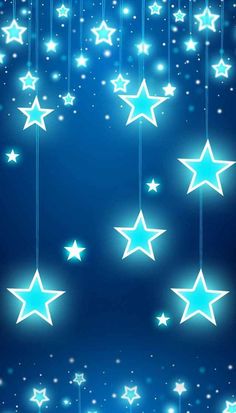 stars are hanging from strings against a blue background