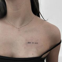 a woman's chest with the words, she is art written in cursive font