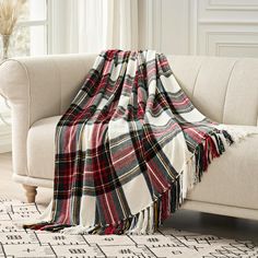 a plaid blanket draped over a couch in a living room