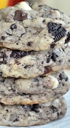 a stack of cookies with chocolate chips and marshmallows in the middle on a table