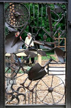 an iron gate that has been made to look like it is being used as a sculpture