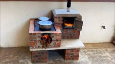 an outdoor oven made out of bricks with a pot on the stove and pans