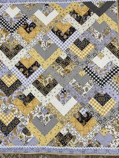 a quilt made with yellow and gray squares