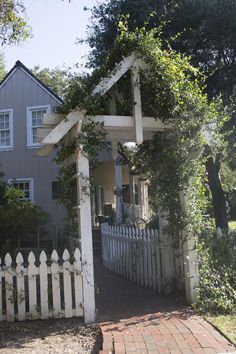 a house with a white picket fence in front of it