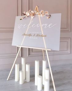 a welcome sign with candles in front of it