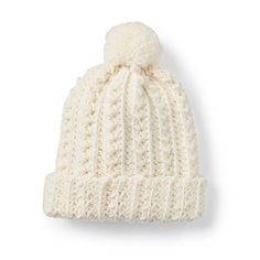 a white knitted hat with a pom - pom