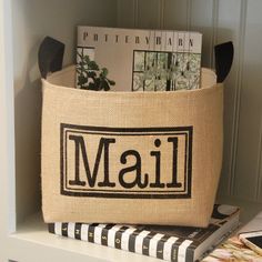 a close up of a book on a shelf near a bag with the word mail