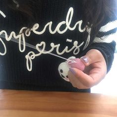 a woman holding a piece of string with the words spread out on her shirt that says, speedy girls