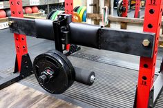 a bench with a pulley on it in a gym area that is being used for strength training