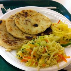 a white plate topped with food on top of a green tray