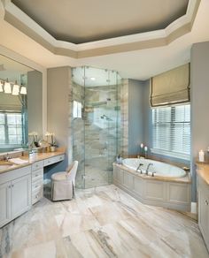 a large bathroom with two sinks and a walk in shower next to a bathtub