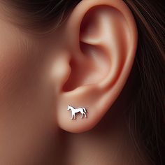 Width: 10mm Gallop into style with these majestic Horse Earrings! 🐎✨ Perfect for equestrians, horse lovers, or anyone who admires the strength and grace of these noble animals, these earrings capture the spirit and beauty of horses. Crafted in sterling silver, solid 14k yellow gold, rose gold, or white gold, these minimalist horse earrings are a sophisticated and heartfelt tribute to the bond between humans and horses. Whether you're a rider, a horse enthusiast, or simply charmed by their elegance, these earrings are a splendid addition to your jewelry collection. These Horse Earrings are more than just a fashion statement; they're a celebration of the majestic and loyal nature of horses. Ideal as a gift for someone special in the equestrian community or as a personal emblem of your love Horse Items, Horse Outfits, Equestrian Necklace, Lover Earrings, Schmuck Gold, Horse Earrings, Gold Horse, Cowgirl Jewelry, Silver Horse