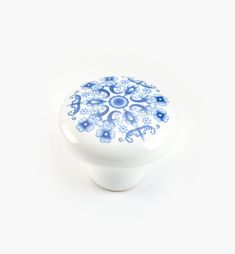 a blue and white ceramic cabinet knob on a white background