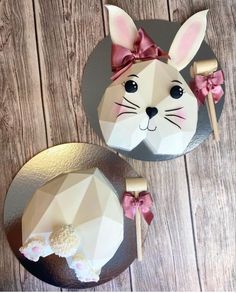 two paper rabbits with bows on their ears and one bunny holding a knife in it's mouth