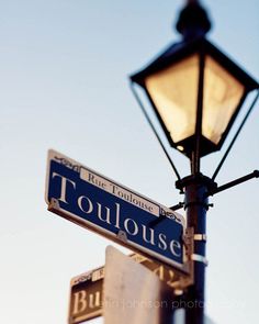 a street light with street signs attached to it French Quarter Art, Louisiana Photography, New Orleans Photography, Noir Tattoo, New Orleans Street, Travel Photos Display, New Orleans History, Erin Johnson, New Orleans Art