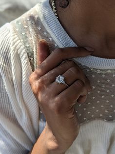 a close up of a person wearing a diamond ring