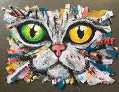 a painting of a cat's face made out of torn up pieces of paper