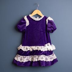 Vintage Jane Darling purple velour and lace ruffled dress.  Soft and stretchy material. In very good vintage condition. Best for 2/3T measures:  13" pit to pit,  20" long * *  BUNDLE + SAVE --   ANY SHIPPING OVERAGES WILL BE REFUNDED IMMEDIATELY, AND BUYER WILL BE CHARGED ONE FLAT RATE PER ORDER. no returns.  Standard shipping for Canada is untracked lettermail.  Standard shipping for USA is regular untracked surface shipping .  If you need quicker shipping or tracking, please upgrade at checkou Violet Vintage, Lace Ruffle Dress, Ruffled Dress, Vintage Purple, 80s Vintage, Lace Ruffle, Stretchy Material, Lace Dress, Violet