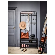 an image of a closet with shoes and hats on it's rack, in front of a door