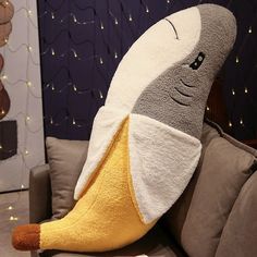 a stuffed banana sitting on top of a couch