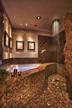 a bathroom with a large jacuzzi tub next to a sink and shower head