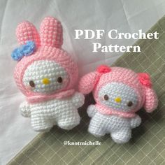 two crocheted hello kitty dolls sitting next to each other