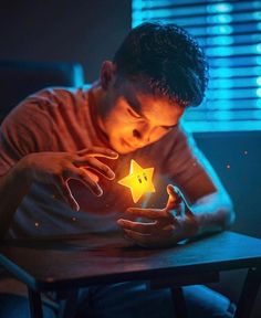 a man sitting at a table holding a star shaped object