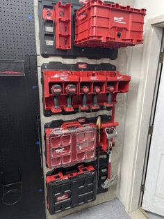 several red and black boxes are hanging on the wall next to each other in a garage