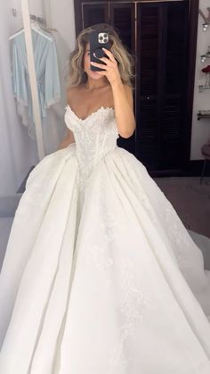 a woman taking a selfie in her wedding dress