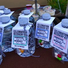 several water bottles with candy in them on a table