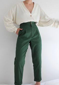 The Oliver Pant is an everyday go-to pant that features a flattering classic high waist, side seam pockets, front pleat detailing, and a cuffed straight tapered leg. This hero fabric is comparable to the feel of vintage khaki chinos; lightweight, and substantial, with that already broken-in feel. One of the first original Na Nin designs, coveted and beloved by many - we're pleased to reintroduce our Oliver Pants in beautiful french cotton twill with updated sizing and grading in this beautiful f Green Chinos For Work, Green Workwear Bottoms With Welt Pockets, Classic High Waist Chinos With Belt Loops, Chic Khaki Cargo Pants For Work, Classic Green Workwear Chinos, Classic Green Chinos For Workwear, High Waist Green Cargo Pants For Workwear, Fall High-waisted Tapered Chinos, Fall Tapered High-waisted Chinos