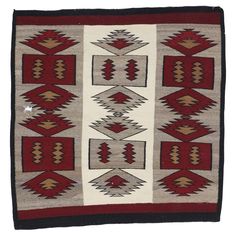 an old navajo rug with red and beige colors