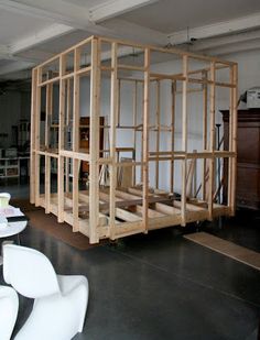 an unfinished room with white chairs and tables in it's centerpieces on the floor