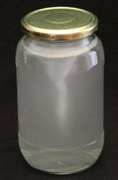 an empty glass jar with a gold lid