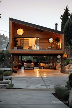 a car is parked in front of a house with lights on the windows and doors